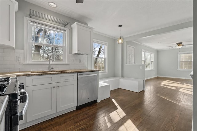 kitchen with dark wood-style floors, a sink, decorative backsplash, dishwasher, and gas range