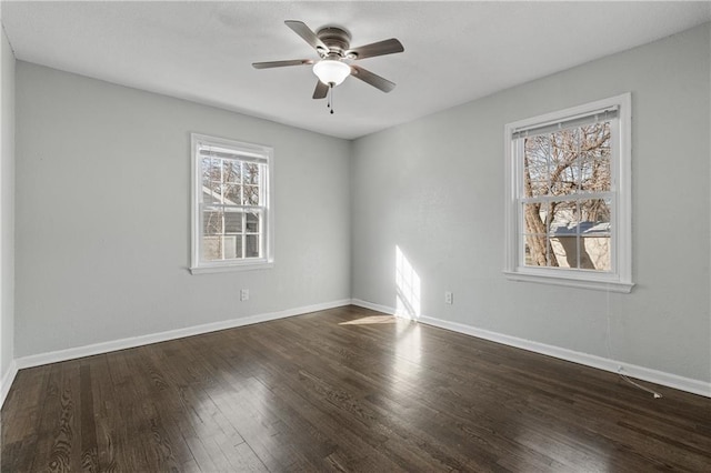 spare room with baseboards, ceiling fan, and wood finished floors