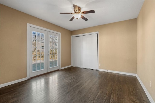 unfurnished bedroom with access to outside, wood finished floors, and baseboards