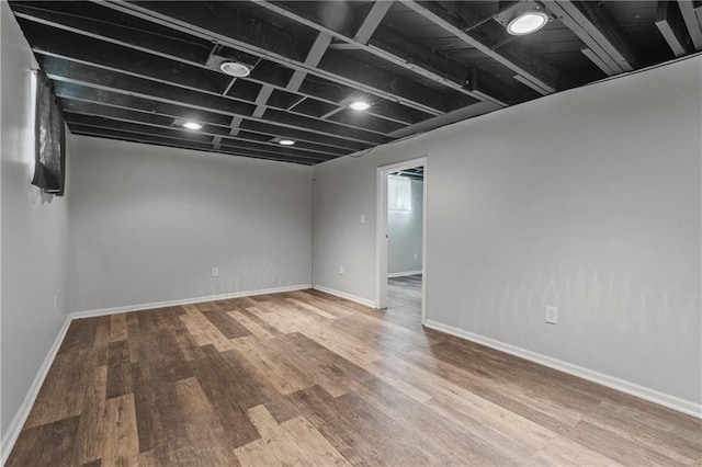 finished basement with baseboards and wood finished floors