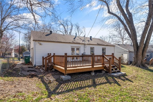 back of property with a gate, roof with shingles, a wooden deck, a yard, and a fenced backyard