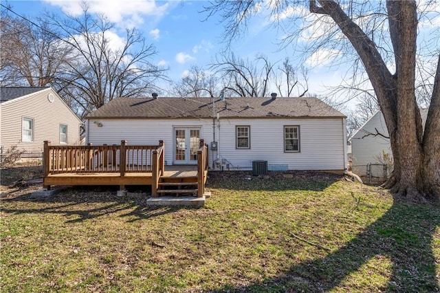 rear view of property featuring french doors, central air condition unit, a yard, and a wooden deck