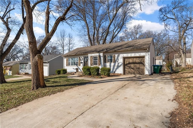 ranch-style home featuring concrete driveway and an attached garage