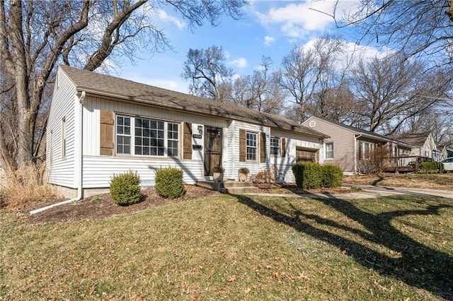 ranch-style home with a front yard, an attached garage, and driveway