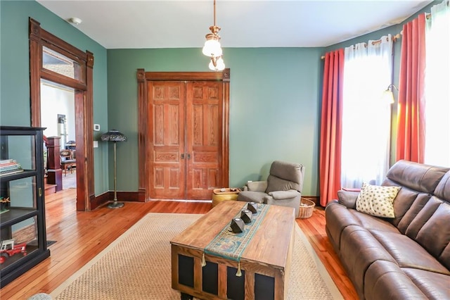 living room with baseboards and wood finished floors