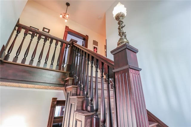 staircase with a chandelier