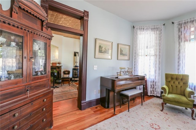 living area featuring light wood finished floors and baseboards