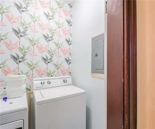 washroom featuring laundry area, washing machine and dryer, and electric panel