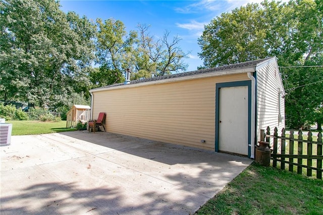 view of shed featuring fence