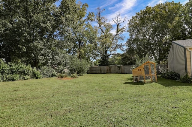 view of yard with fence and an outbuilding