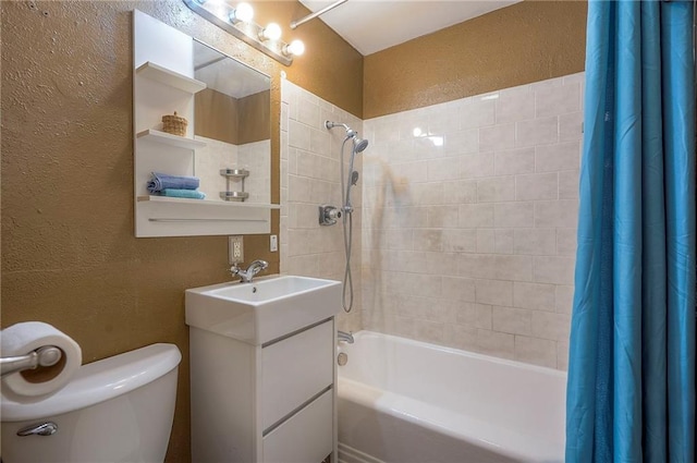 full bathroom featuring a textured wall, vanity, shower / bath combination with curtain, and toilet