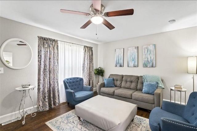 living area featuring baseboards, ceiling fan, and wood finished floors