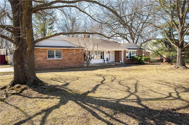 single story home featuring brick siding