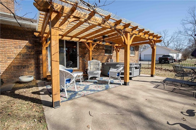 view of patio featuring a pergola, a hot tub, and fence