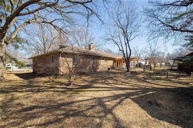 exterior space with fence and a chimney