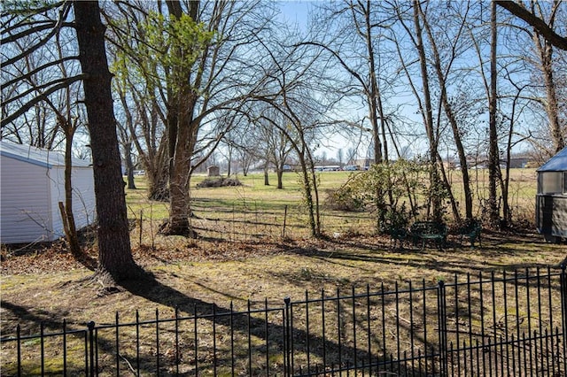 view of yard with an outdoor structure and fence