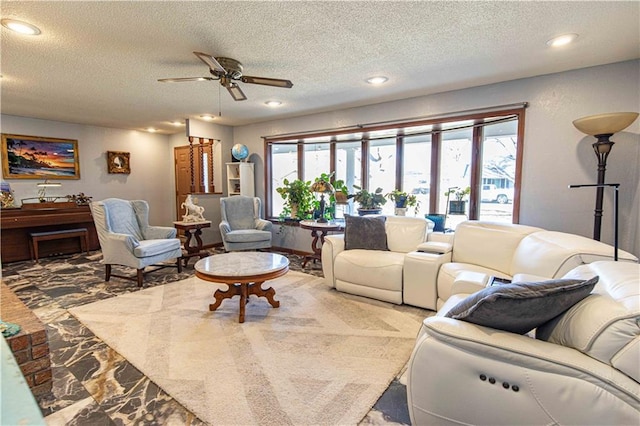 living area with recessed lighting, a textured ceiling, and a ceiling fan