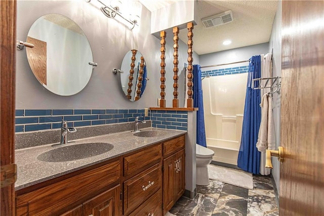 bathroom featuring visible vents, toilet, a textured ceiling, and a sink