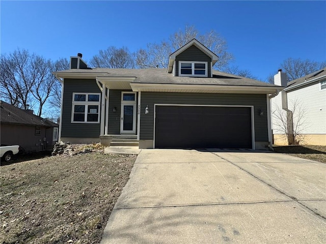 view of front of property featuring concrete driveway, a chimney, and an attached garage