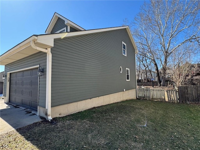 view of property exterior with a garage, a yard, and fence