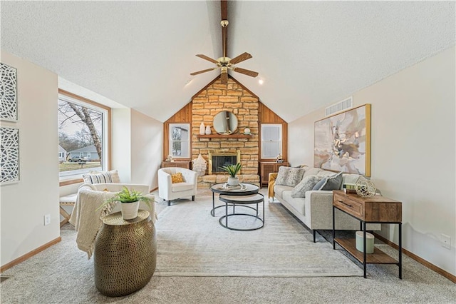 carpeted living room featuring vaulted ceiling with beams, a fireplace, visible vents, a textured ceiling, and baseboards