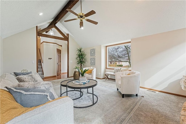 carpeted living room with lofted ceiling with beams, stairs, baseboards, and a ceiling fan