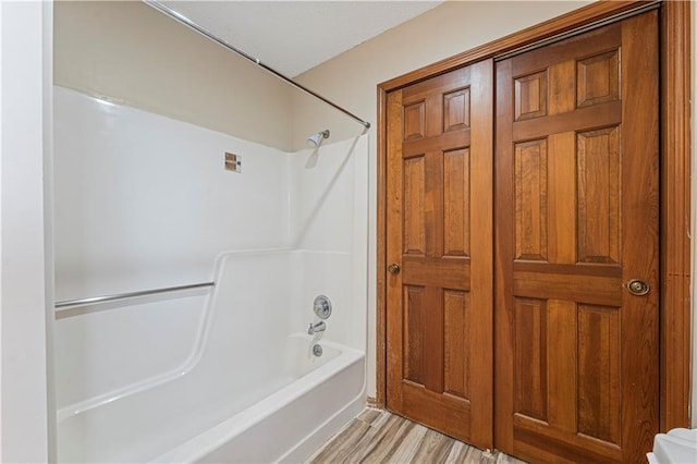 full bathroom with  shower combination and wood finished floors