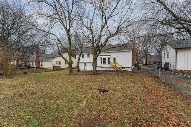 rear view of house featuring a yard, a chimney, central AC unit, crawl space, and fence private yard