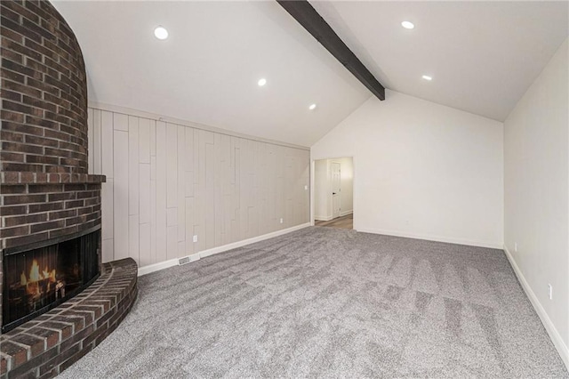 unfurnished living room featuring baseboards, lofted ceiling with beams, carpet, a brick fireplace, and recessed lighting