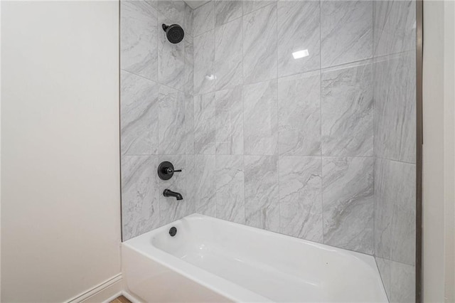 bathroom featuring  shower combination and baseboards