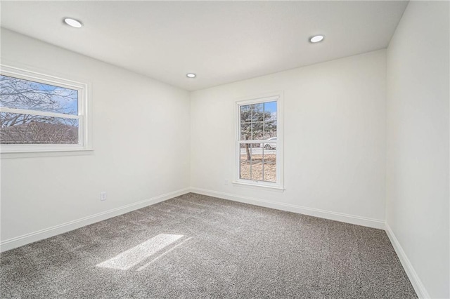 carpeted spare room featuring recessed lighting and baseboards