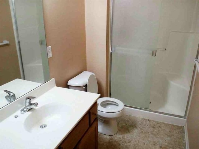 full bath featuring vanity, a shower stall, and toilet