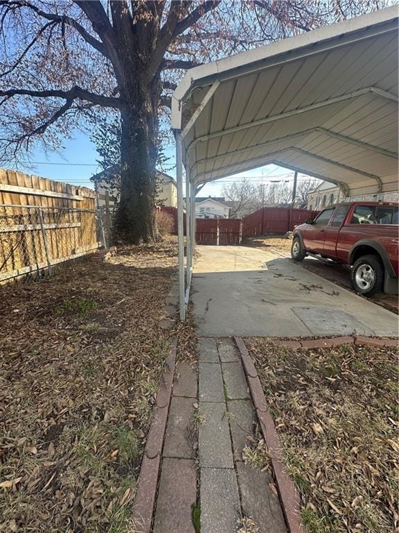 view of yard with fence and a detached carport