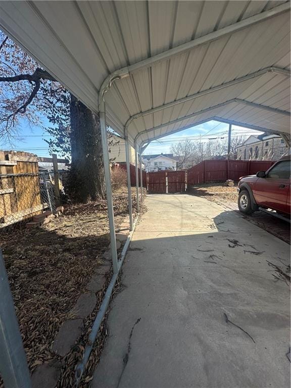 exterior space featuring a carport and fence