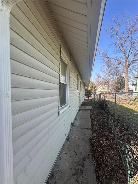 view of side of home with fence