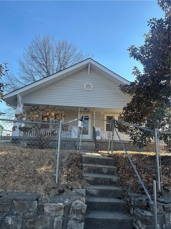 view of front of home featuring covered porch and fence