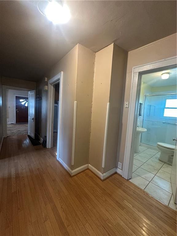 hallway featuring light wood-style flooring