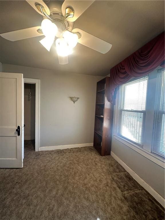 unfurnished bedroom featuring ceiling fan, baseboards, and carpet flooring