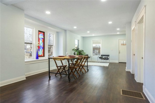 dining room with baseboards, visible vents, wood finished floors, and recessed lighting