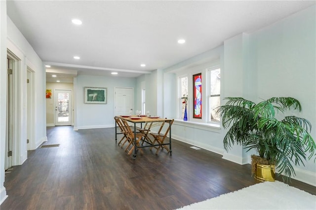 dining space with recessed lighting, wood finished floors, and baseboards