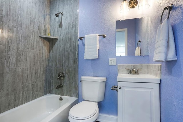 bathroom with a textured wall, toilet, vanity, baseboards, and  shower combination