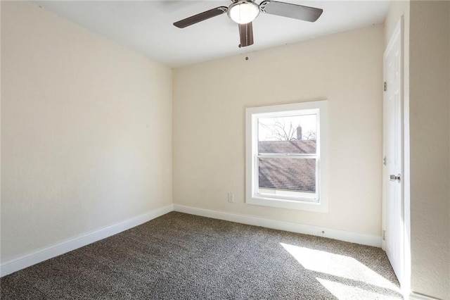 carpeted empty room with ceiling fan and baseboards