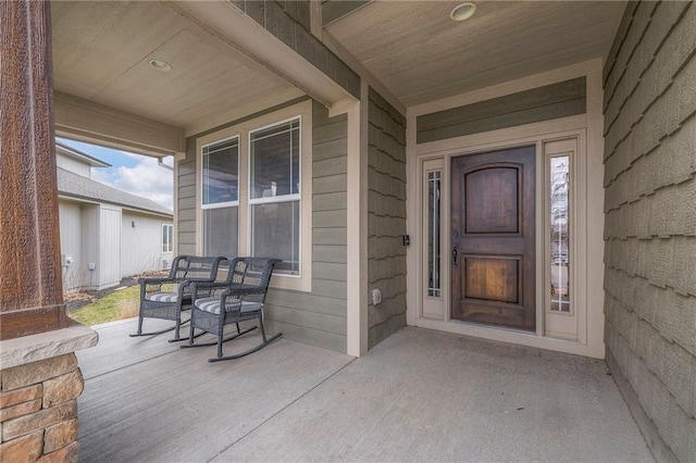 entrance to property featuring covered porch