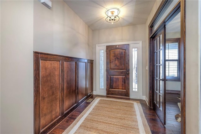 entrance foyer with dark wood finished floors and baseboards