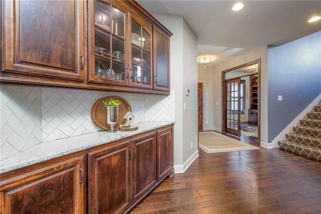 bar with baseboards, dark wood-style floors, stairway, backsplash, and recessed lighting