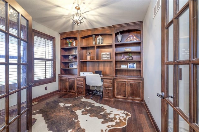 home office featuring french doors, dark wood finished floors, visible vents, built in study area, and baseboards