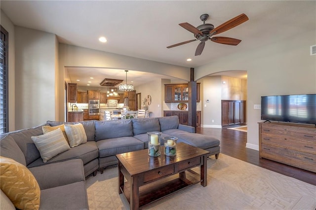 living area featuring baseboards, visible vents, a ceiling fan, light wood-type flooring, and recessed lighting