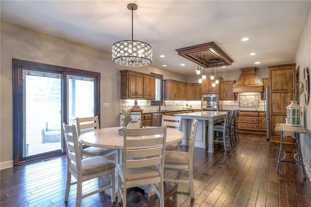 dining space featuring dark wood-type flooring and recessed lighting