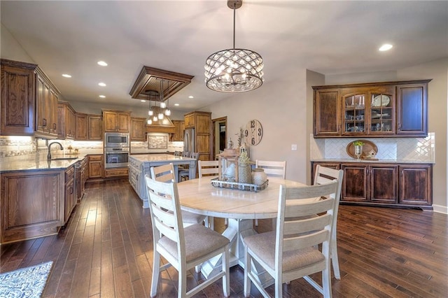 dining area with dark wood-style floors and recessed lighting