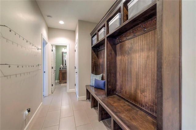 mudroom with baseboards and light tile patterned floors